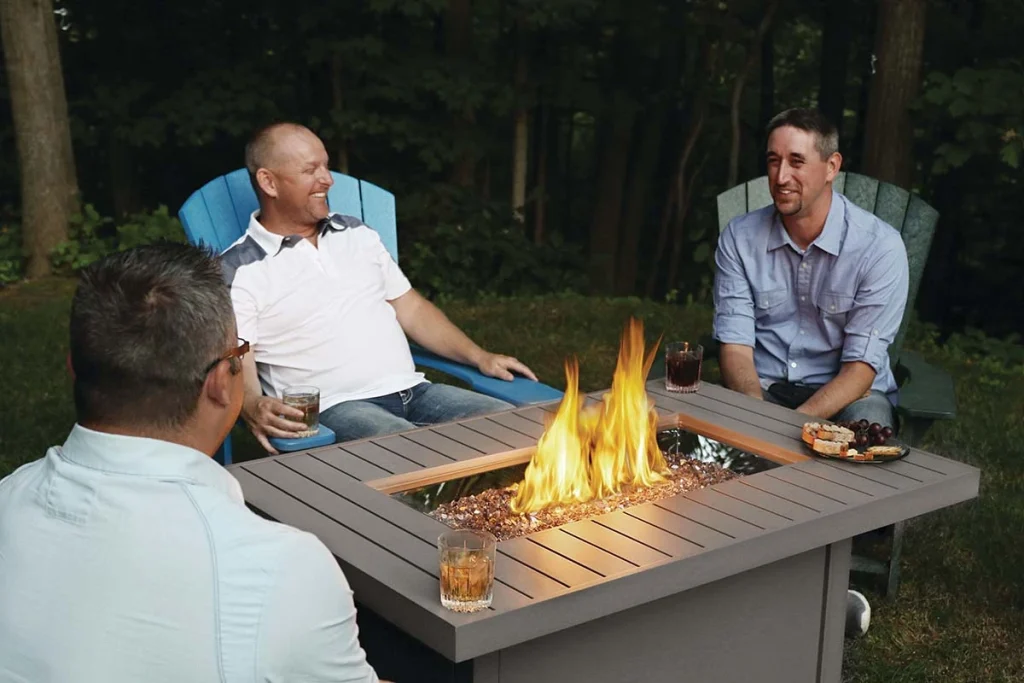 Three men socializing and enjoying the health benefits of a fire table