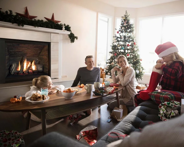 A family enjoying holiday and Christmas fireplace fun