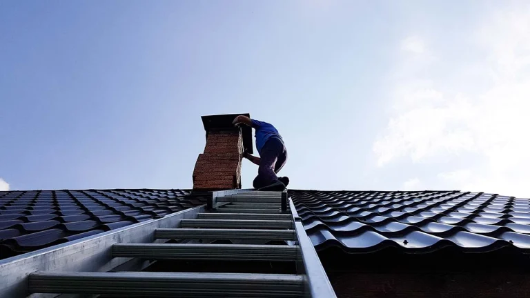 Technician inspecting a chimney on the roof for an annual fireplace inspection in the GTA